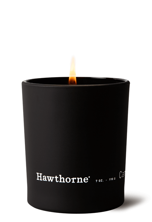 The hawthorne Smoky Palo Santo Candle in a matte black glass container fills your space with signature palo santo scent, featuring white branding on the front.