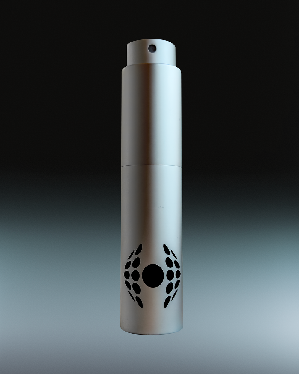 The Hawthorne Refillable Travel Cologne Atomizer features a metallic cylindrical design with a black circular and dot pattern on its lower half, shown against a gradient background. Add cologne to cart and use code: SPRAYFREE.