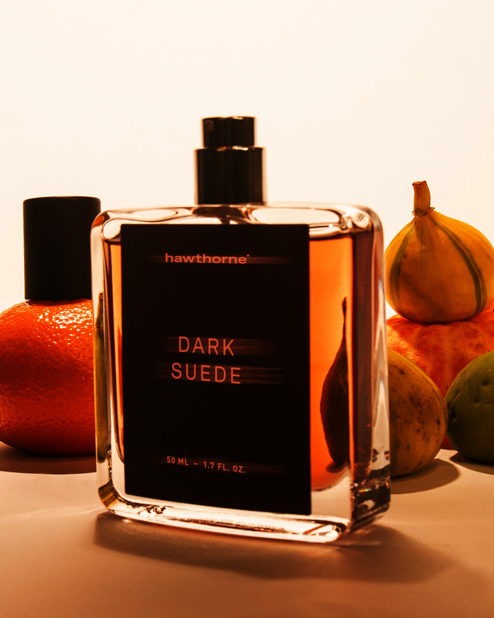 image of dark suede bottle without cap and fruits around in the background