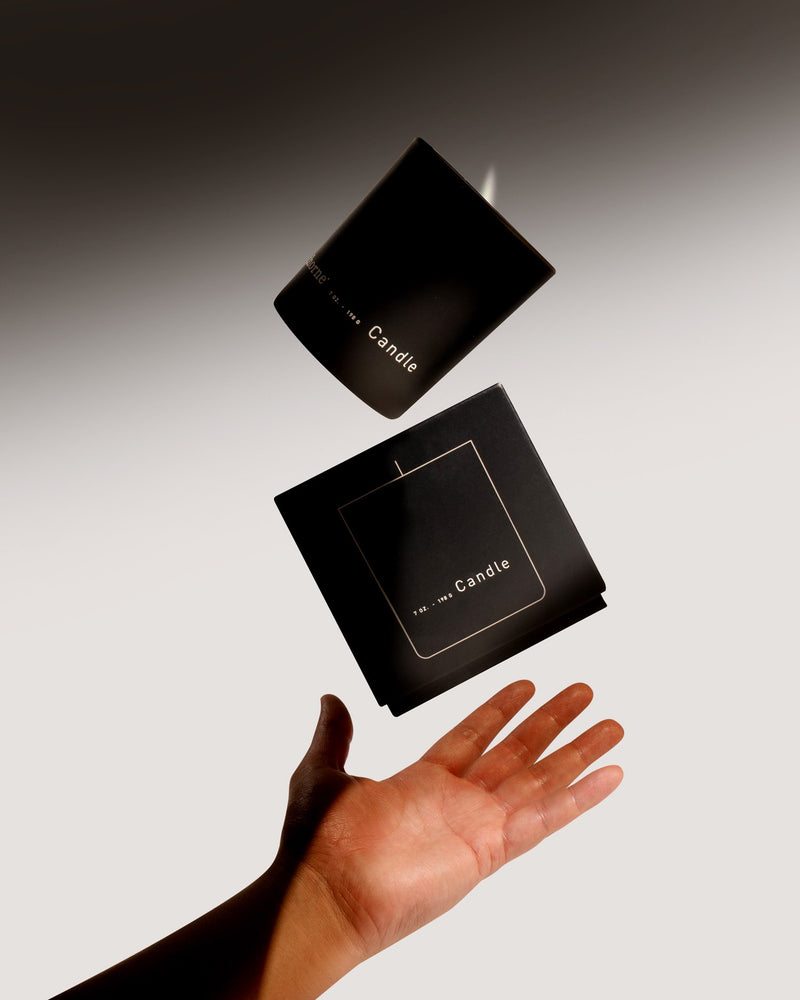 candle with box and human hand